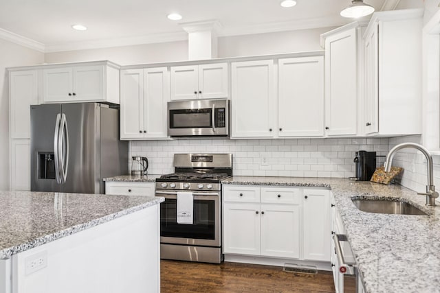 1361 Neil Rd, Chapel Hill, TN 37034 - kitchen featuring stainless steel appliances, white cabinets, crown molding, dark wood finished floors, and light stone counters