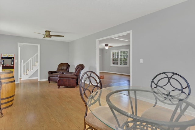 5347 Shady Grove Rd, Morrison, TN 37357 - dining space featuring ceiling fan, light wood-style flooring, and stairway