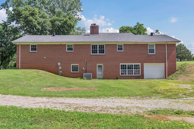 5347 Shady Grove Rd, Morrison, TN 37357 - rear view of house with an attached garage, a chimney, a lawn, and brick siding