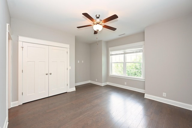 1019 N Maple St Unit 2D, Murfreesboro, TN 37130 - unfurnished bedroom featuring dark wood-type flooring, a ceiling fan, and a closet