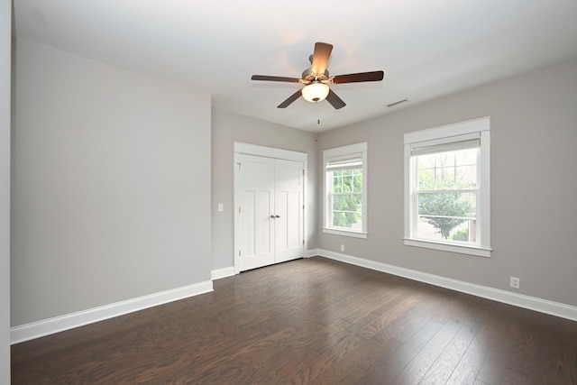 1019 N Maple St Unit 2D, Murfreesboro, TN 37130 - unfurnished bedroom with dark wood-type flooring, a closet, and ceiling fan