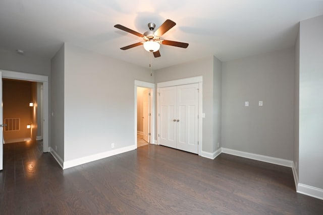 1019 N Maple St Unit 2D, Murfreesboro, TN 37130 - unfurnished bedroom with dark wood-style floors, a closet, and a ceiling fan