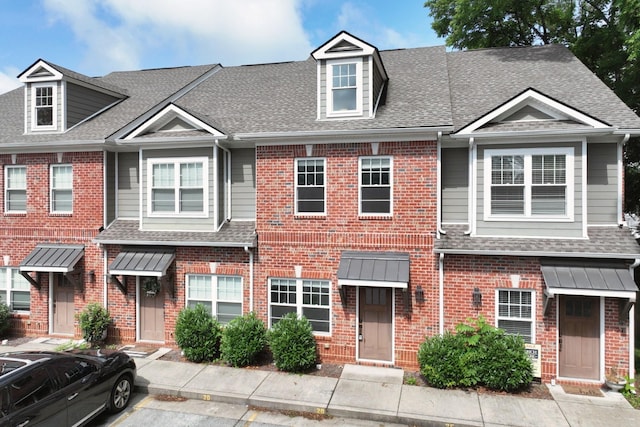 1019 N Maple St Unit 2D, Murfreesboro, TN 37130 - view of property with a shingled roof, brick siding, and uncovered parking