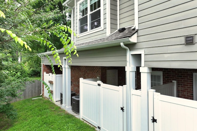 1019 N Maple St Unit 2D, Murfreesboro, TN 37130 - view of side of property featuring brick siding and a shingled roof