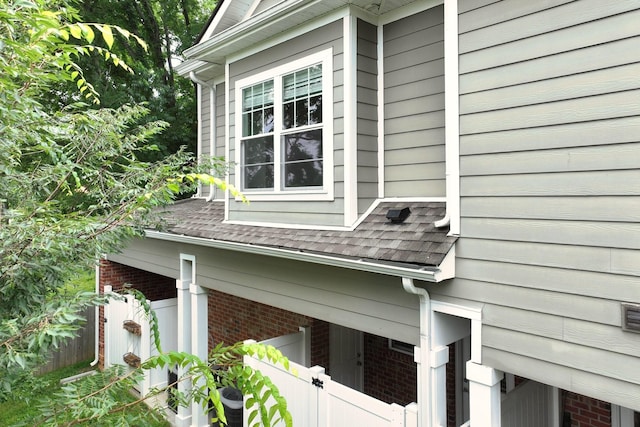 1019 N Maple St Unit 2D, Murfreesboro, TN 37130 - view of side of home featuring a shingled roof and brick siding