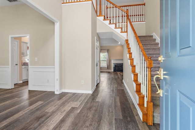 4061 Locerbie Cir, Spring Hill, TN 37174 - entrance foyer featuring dark wood-style floors, stairway, a towering ceiling, and a wainscoted wall