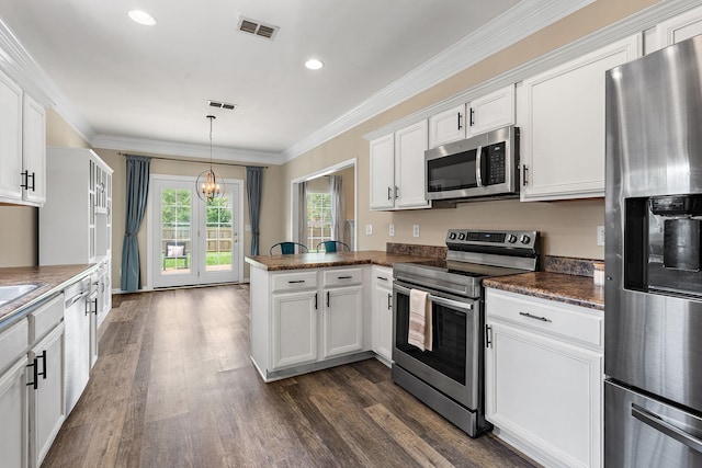 4061 Locerbie Cir, Spring Hill, TN 37174 - kitchen featuring appliances with stainless steel finishes, a chandelier, white cabinets, a peninsula, and dark wood-style floors