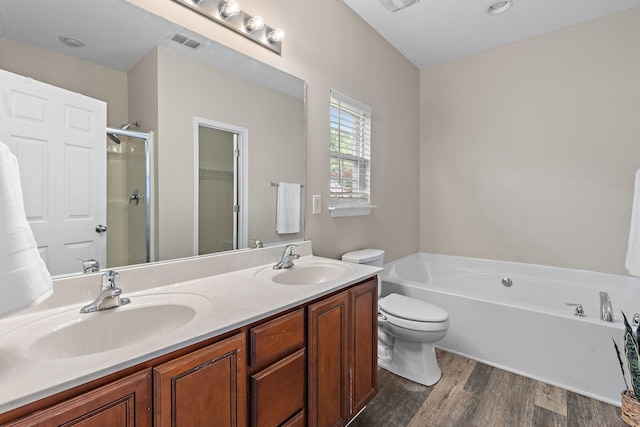 4061 Locerbie Cir, Spring Hill, TN 37174 - bathroom with a bath, double vanity, a shower stall, wood finished floors, and a walk in closet