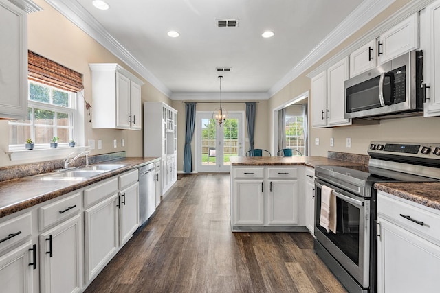 4061 Locerbie Cir, Spring Hill, TN 37174 - kitchen with stainless steel appliances, dark wood-type flooring, a peninsula, white cabinets, and dark countertops