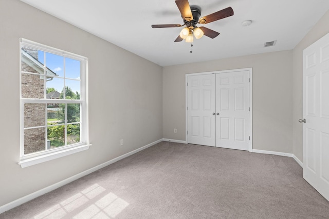 4061 Locerbie Cir, Spring Hill, TN 37174 - unfurnished bedroom with carpet, a closet, and a ceiling fan