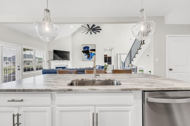 329 Clarabelle Ln, Clarksville, TN 37040 - kitchen with dishwasher, open floor plan, light stone countertops, a fireplace, and vaulted ceiling