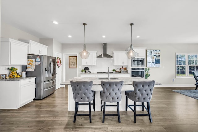 329 Clarabelle Ln, Clarksville, TN 37040 - kitchen featuring wall chimney range hood, stainless steel appliances, tasteful backsplash, a kitchen breakfast bar, and recessed lighting