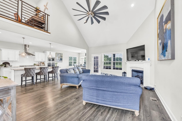 329 Clarabelle Ln, Clarksville, TN 37040 - living room with high vaulted ceiling, ceiling fan, dark wood-style flooring, a glass covered fireplace, and recessed lighting
