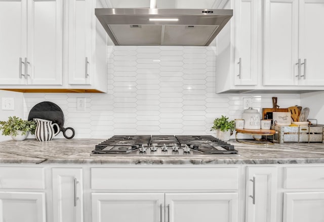 329 Clarabelle Ln, Clarksville, TN 37040 - kitchen with wall chimney range hood, stainless steel gas stovetop, white cabinetry, and decorative backsplash
