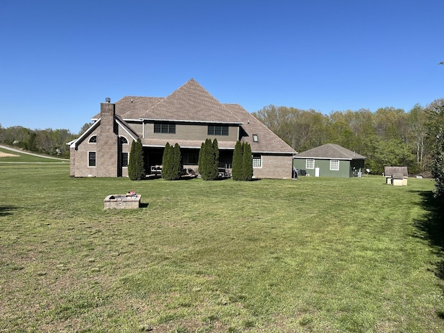 236 Tims Ford Dr, Winchester, TN 37398 - back of property featuring a chimney, a yard, and a fire pit