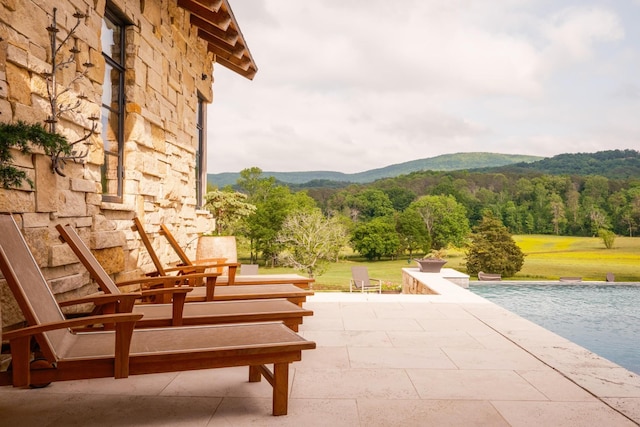 6971 W Cove Rd, Chickamauga, GA 30707 - view of patio with a mountain view, an infinity pool, and a forest view