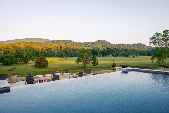 6971 W Cove Rd, Chickamauga, GA 30707 - view of swimming pool with a fire pit, an infinity pool, a mountain view, a view of countryside, and a patio area