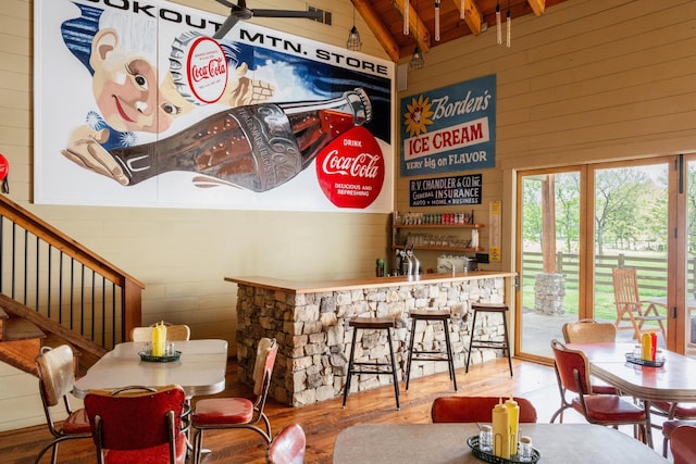 6971 W Cove Rd, Chickamauga, GA 30707 - dining area with wooden walls, wood finished floors, a bar, stairs, and wooden ceiling