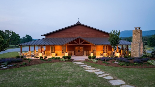 6971 W Cove Rd, Chickamauga, GA 30707 - rear view of property featuring a porch, a lawn, and a metal roof
