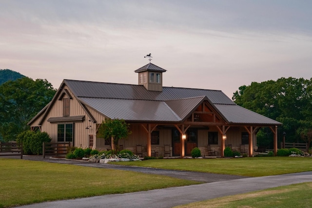 6971 W Cove Rd, Chickamauga, GA 30707 - view of front of house featuring a lawn, a metal roof, a porch, and board and batten siding