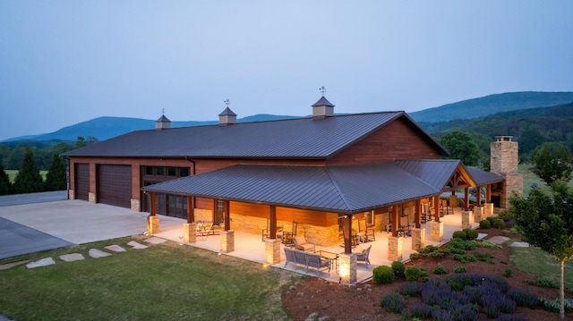 6971 W Cove Rd, Chickamauga, GA 30707 - rear view of property with a mountain view, driveway, a metal roof, stone siding, and a standing seam roof