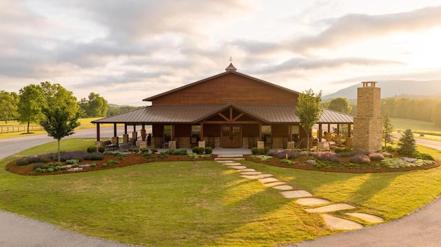 6971 W Cove Rd, Chickamauga, GA 30707 - view of front of home with a front yard, covered porch, a metal roof, and stone siding