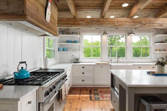 1170 Ascalon Rd, Rising Fawn, GA 30738 - kitchen with appliances with stainless steel finishes, open shelves, custom range hood, light wood-style flooring, and white cabinets