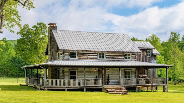 1170 Ascalon Rd, Rising Fawn, GA 30738 - rear view of house with a chimney, a lawn, a metal roof, covered porch, and a standing seam roof