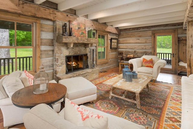 1170 Ascalon Rd, Rising Fawn, GA 30738 - living room featuring hardwood / wood-style flooring, wooden walls, a fireplace, and beamed ceiling