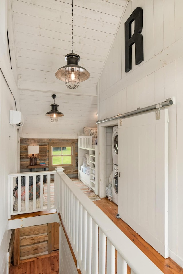 1170 Ascalon Rd, Rising Fawn, GA 30738 - hall featuring stacked washer / dryer, wooden ceiling, wood finished floors, lofted ceiling, and an AC wall unit