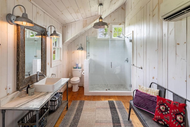 1170 Ascalon Rd, Rising Fawn, GA 30738 - full bathroom with a wall unit AC, wood walls, wood finished floors, vanity, and a stall shower
