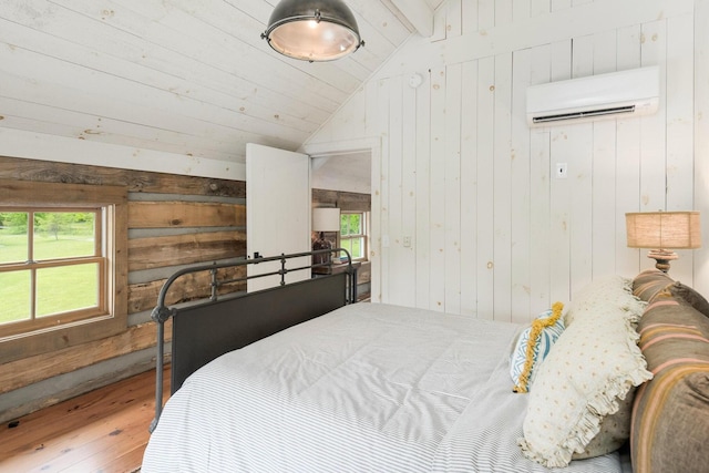 1170 Ascalon Rd, Rising Fawn, GA 30738 - bedroom featuring a wall unit AC, hardwood / wood-style flooring, wooden walls, multiple windows, and a closet