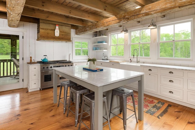 1170 Ascalon Rd, Rising Fawn, GA 30738 - kitchen featuring stainless steel range, a breakfast bar area, a wood ceiling with exposed beams, white cabinetry, and light stone countertops