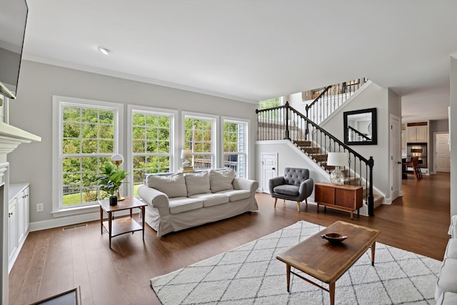 1209 Firth Ct, Franklin, TN 37067 - living room with stairs, ornamental molding, wood finished floors, and a fireplace