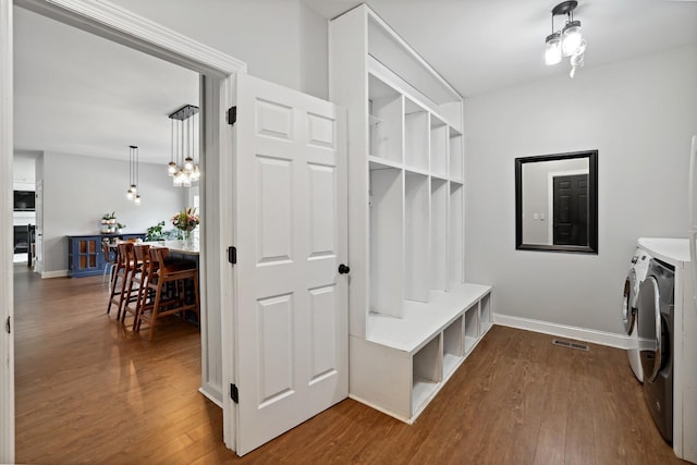 1209 Firth Ct, Franklin, TN 37067 - mudroom with washer and dryer, dark wood-style flooring, and a chandelier