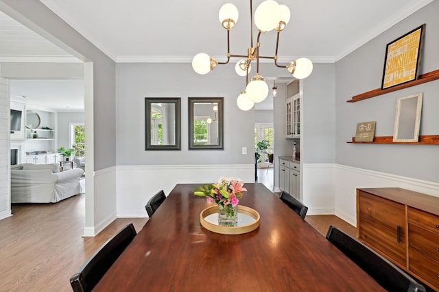 1209 Firth Ct, Franklin, TN 37067 - dining area with wood finished floors, a chandelier, and crown molding
