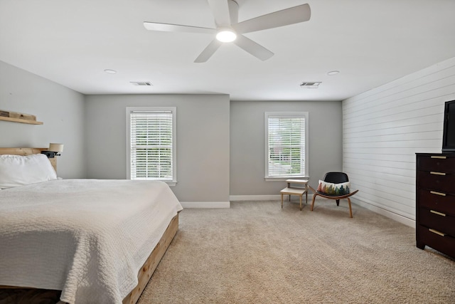 1209 Firth Ct, Franklin, TN 37067 - bedroom with multiple windows, a ceiling fan, light colored carpet, and wood walls