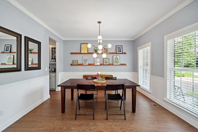 1209 Firth Ct, Franklin, TN 37067 - dining area featuring a chandelier, dark wood-style floors, crown molding, and wainscoting