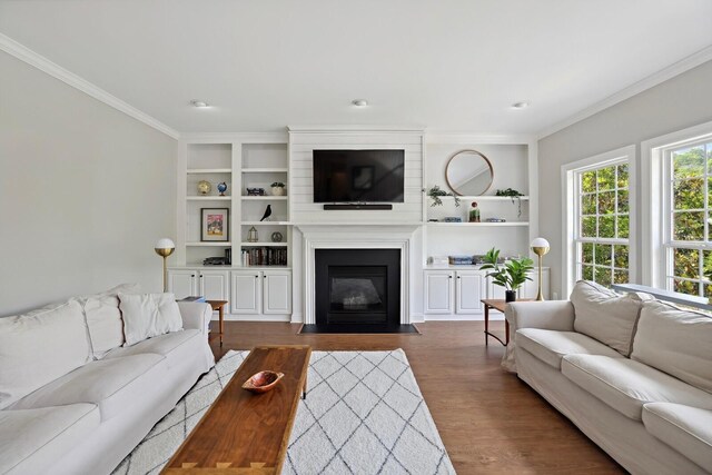 1209 Firth Ct, Franklin, TN 37067 - living room with ornamental molding, dark wood-style floors, built in features, and a fireplace