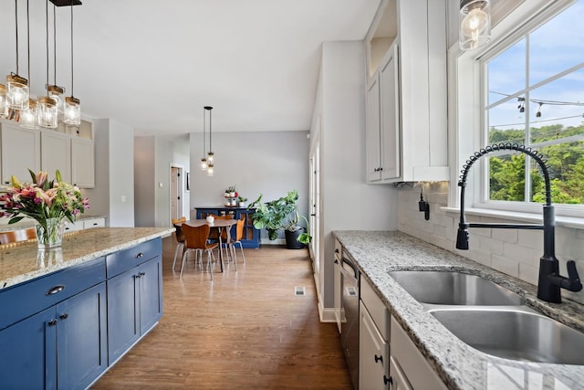1209 Firth Ct, Franklin, TN 37067 - kitchen with blue cabinets, decorative backsplash, wood finished floors, and plenty of natural light