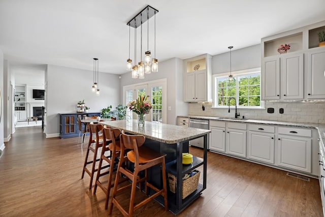 1209 Firth Ct, Franklin, TN 37067 - kitchen featuring stainless steel dishwasher, dark wood finished floors, and tasteful backsplash