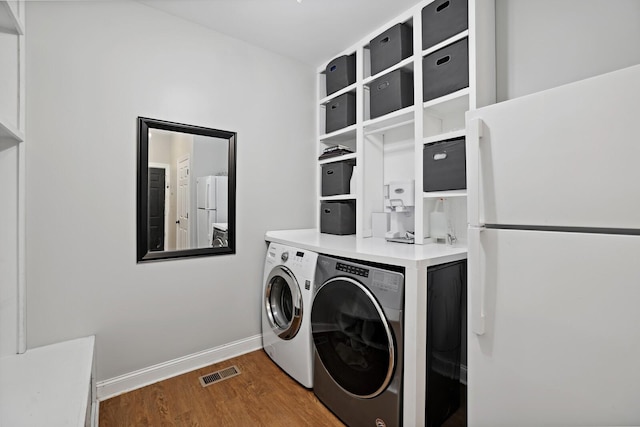1209 Firth Ct, Franklin, TN 37067 - laundry room featuring wood finished floors and separate washer and dryer