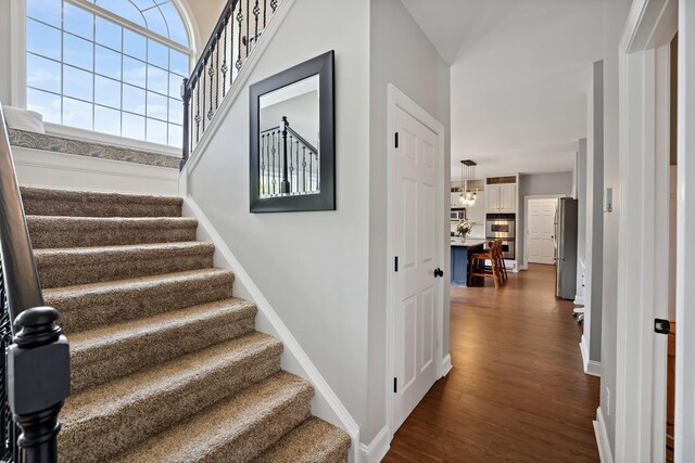 1209 Firth Ct, Franklin, TN 37067 - stairway featuring wood finished floors and a chandelier