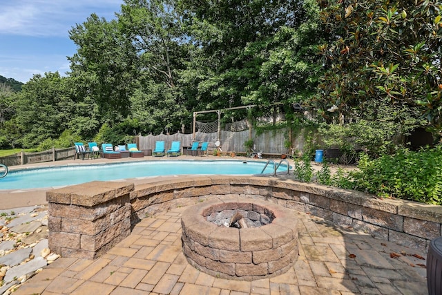 1209 Firth Ct, Franklin, TN 37067 - view of swimming pool with a fenced backyard, a patio, and an outdoor living space with a fire pit