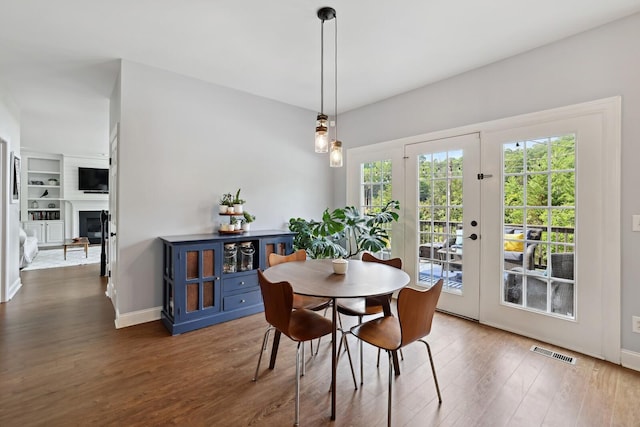 1209 Firth Ct, Franklin, TN 37067 - dining room featuring wood finished floors, a fireplace, and built in features