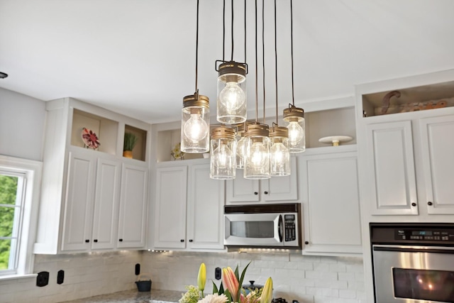 1209 Firth Ct, Franklin, TN 37067 - kitchen with appliances with stainless steel finishes, tasteful backsplash, white cabinets, a chandelier, and open shelves