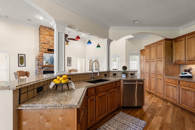 203 Tom Robinson Rd, Franklin, TN 37064 - kitchen featuring stainless steel dishwasher, ornate columns, decorative backsplash, wood finished floors, and light stone countertops