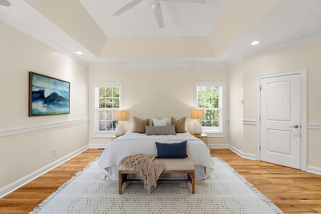 203 Tom Robinson Rd, Franklin, TN 37064 - bedroom featuring multiple windows, light wood-style flooring, a tray ceiling, crown molding, and recessed lighting
