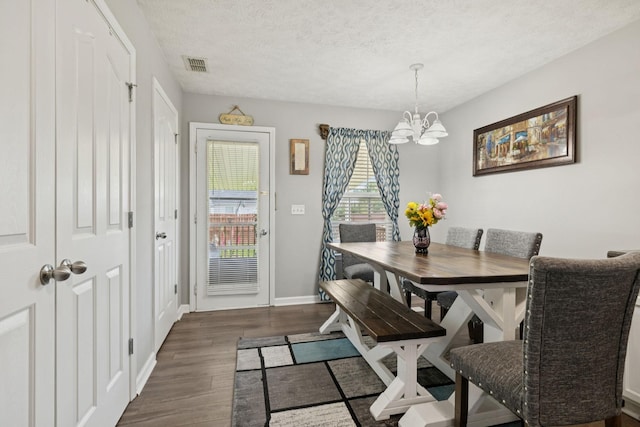 1804 Cason Trl, Murfreesboro, TN 37128 - dining space with a chandelier, dark wood finished floors, and a textured ceiling