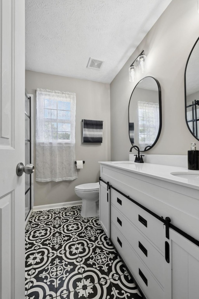 1804 Cason Trl, Murfreesboro, TN 37128 - bathroom with double vanity, a textured ceiling, and a shower with door